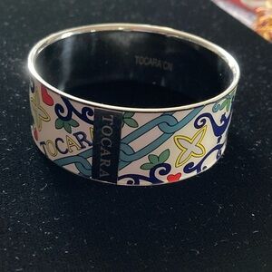 Colorful Enamel Bracelet Vibrant floral & geometric patterns. Features branding.